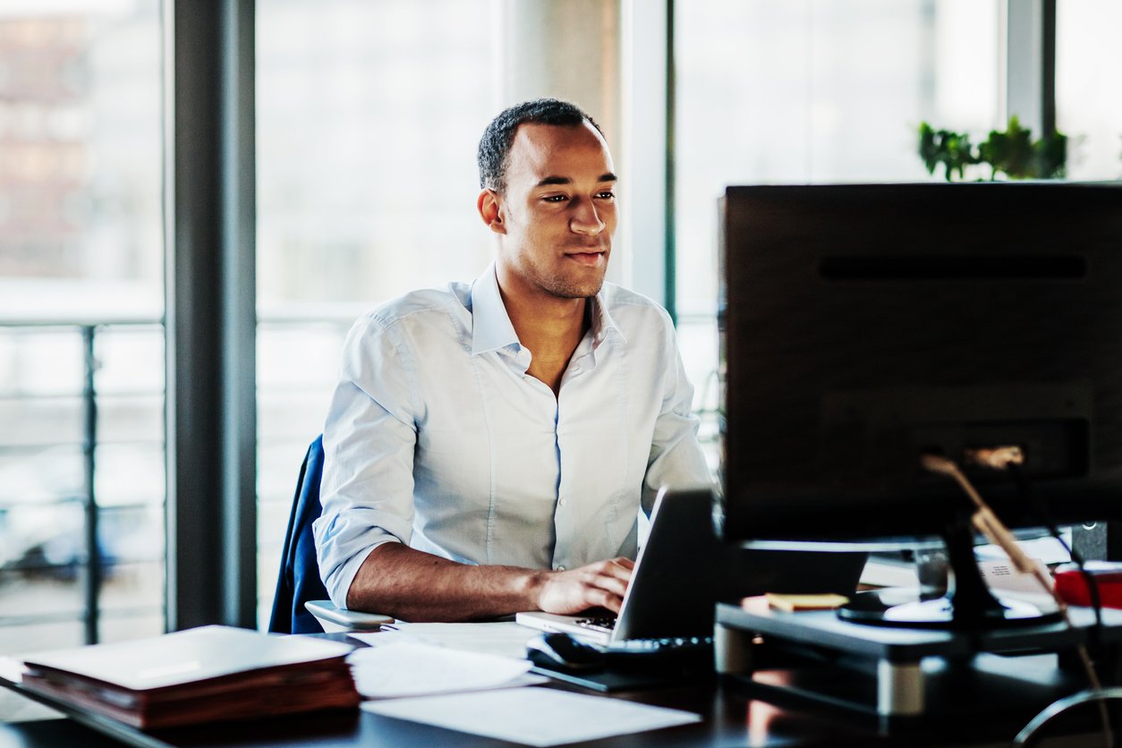 man working on ad copy on computer