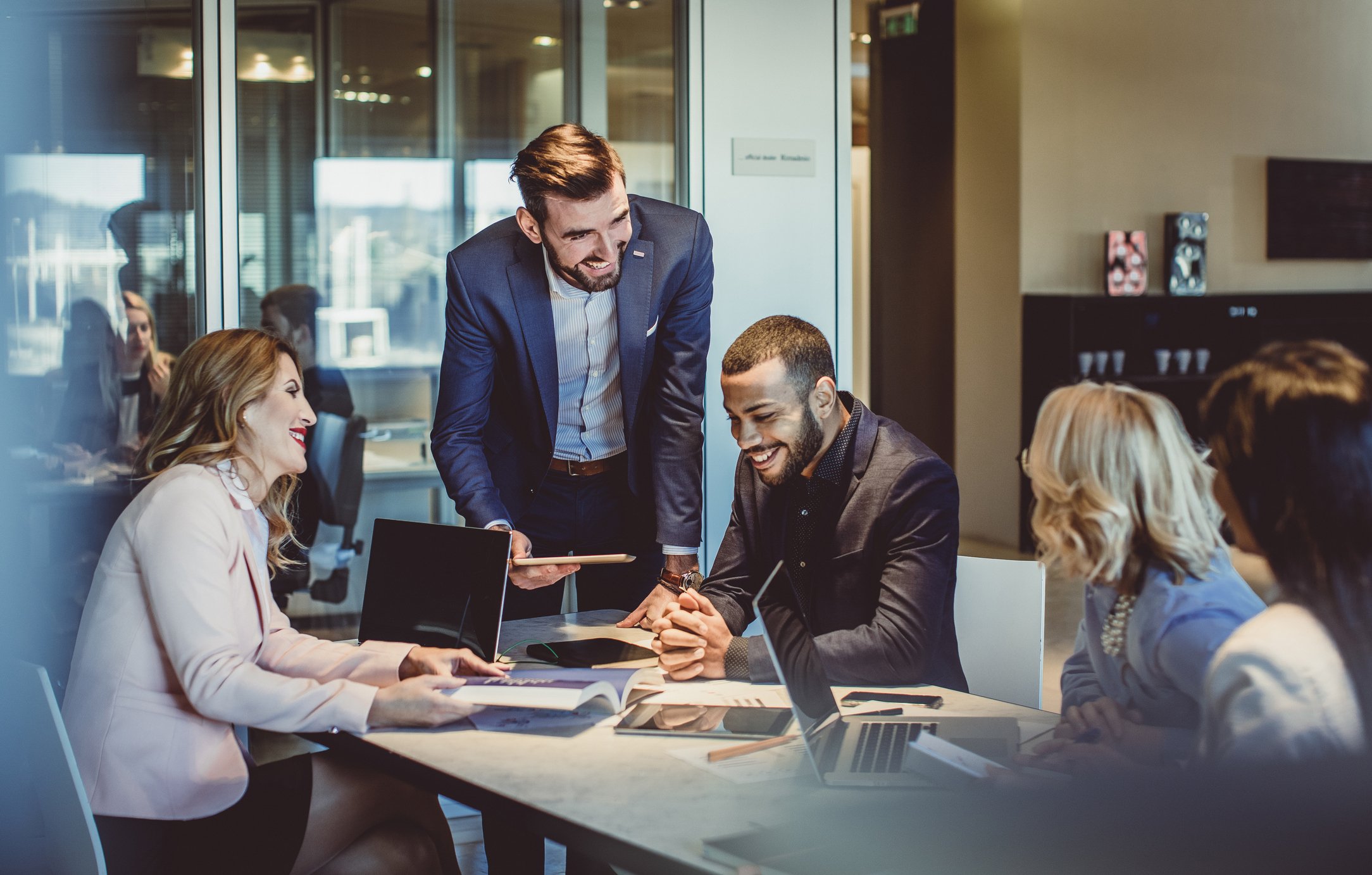 marketing-team-in-conference-room-with-one-colleague-standing